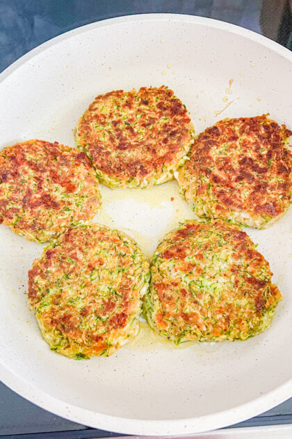 cooked zucchini cakes in a skillet