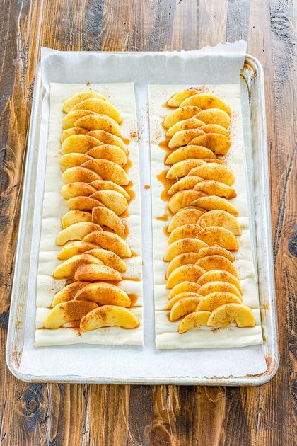 sweetened sliced apples arranged down the center of puff pastry before baking