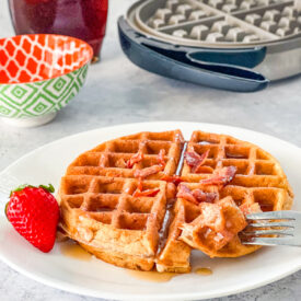 bite of bacon and cinnamon waffle