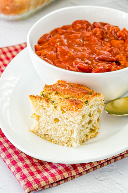 one serving of herbed oatmeal bread with bowl of chili