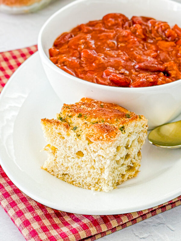 one serving of herbed oatmeal bread with bowl of chili