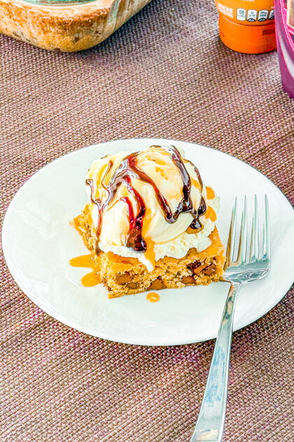 Slice of Chocolate Chip Paradise Pie with caramel and chocolate sauce