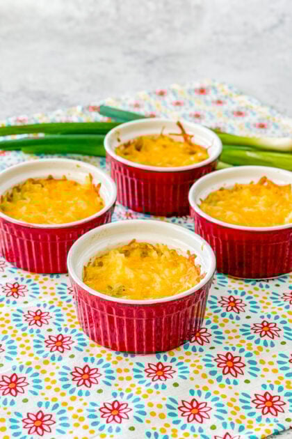 close-up of creamy shredded potatoes au gratin with melted cheese in ramekin