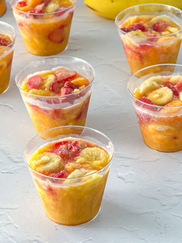 frozen fruit cups including bananas, mandarin oranges, pineapple, bananas, and strawberries