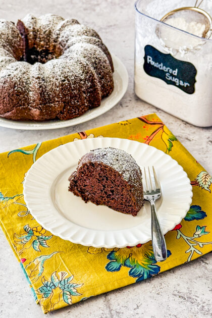 easy chocolate bundt cake recipe with rich, moist crumb and powdered sugar dusting