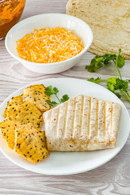 tortilla filled with cheese, chili, and refried beans