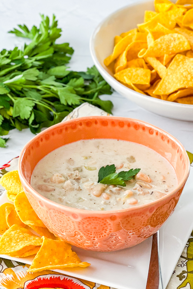 Bowl of white chicken chili with tortilla chips