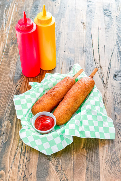 Overhead view of homemade corn dogs served in a basket