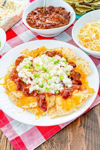 Overhead view of BBQ pulled pork nachos with melted cheese and toppings
