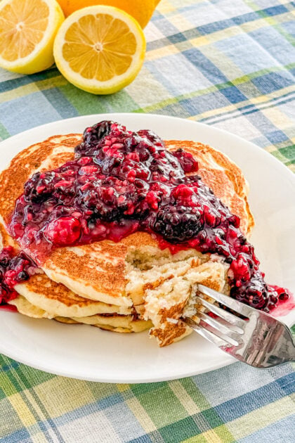Homemade blackberry sauce served over lemon ricotta pancakes