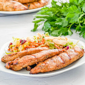 do it all marinated chicken on a plate with salad