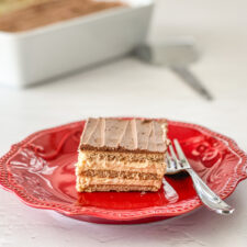 Eclair Pie on a red plate with pie in the background