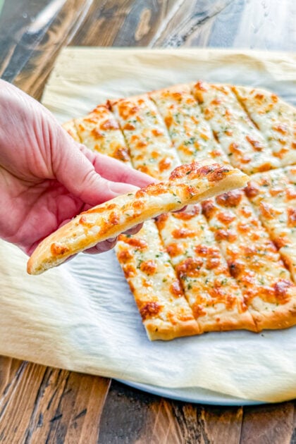Cheesy garlic breadsticks cut into strips for serving
