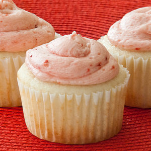 Simple White Cupcakes topped with strawberry frosting