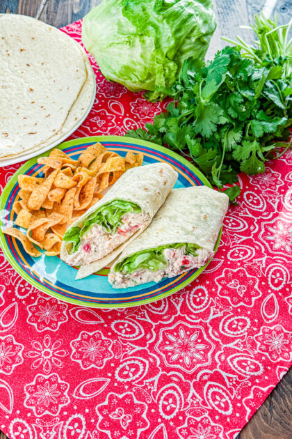 Chicken enchilada salad wrap cut in half and served on a plate
