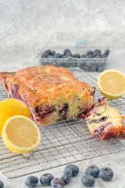 loaf of lemon blueberry bread with slice cut