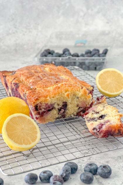 loaf of lemon blueberry bread with slice cut