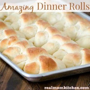 crescent shapped dinner rolls on a baking sheet