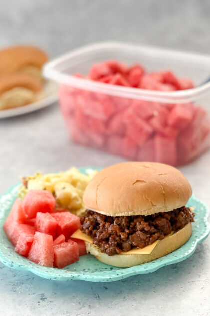 Easy Cheesy Barbecued Sloppy Joe served with watermelon and potato salad