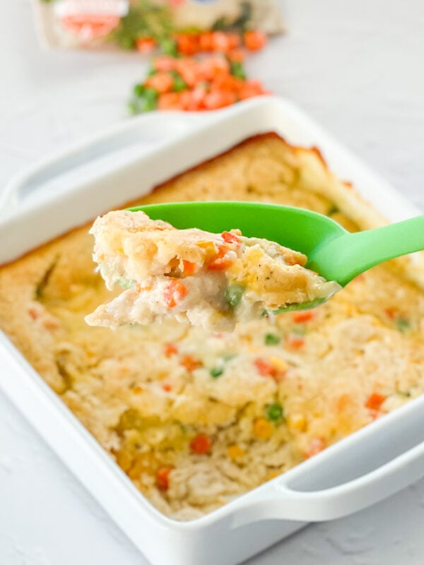 serving up Easy Chicken Cobbler from a white baking pan