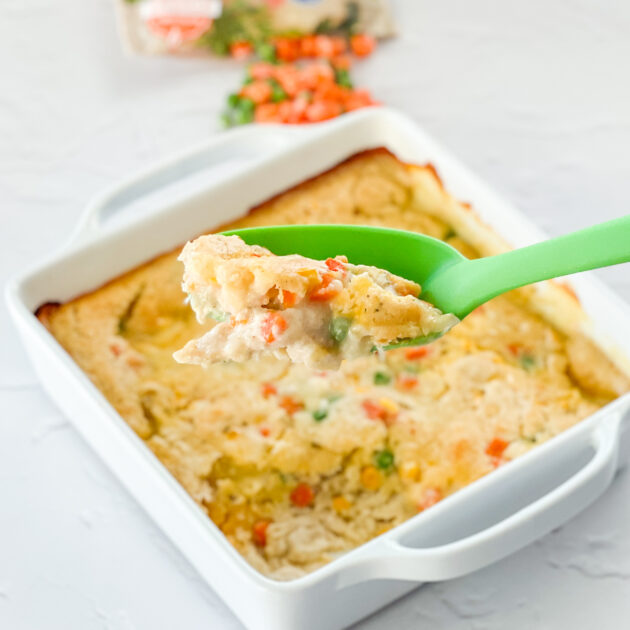 serving up Easy Chicken Cobbler from a white baking pan