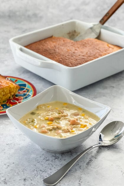 Speedy Green Chile Chicken Enchilada Soup with cornbread in background