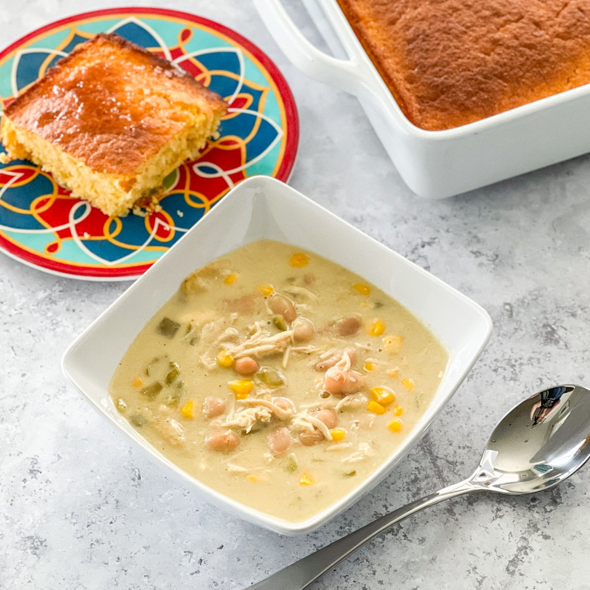 Green Chile Chicken Enchilada Soup In a white bowl