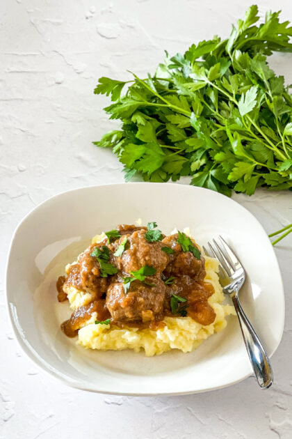 meatballs and gravy served over mashed potatoes