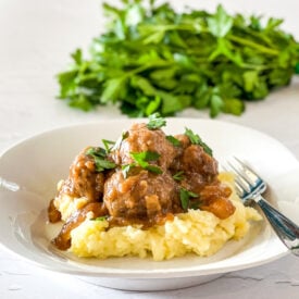 meatballs and gravy served over mashed potatoes