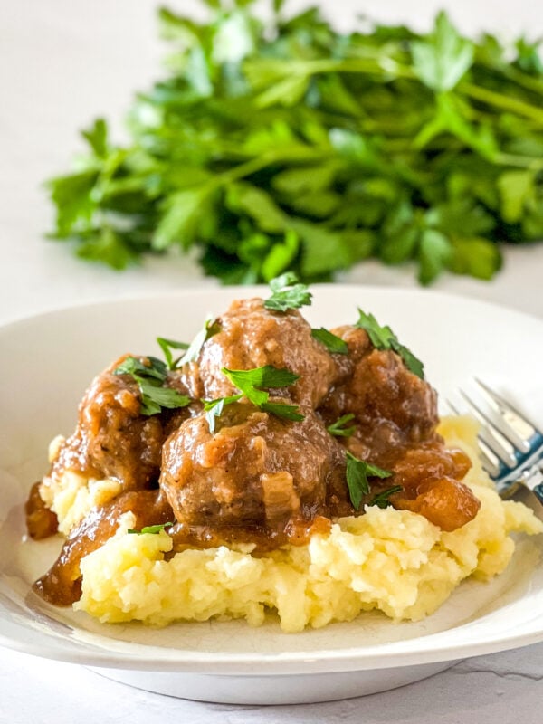 meatballs and gravy served over mashed potatoes