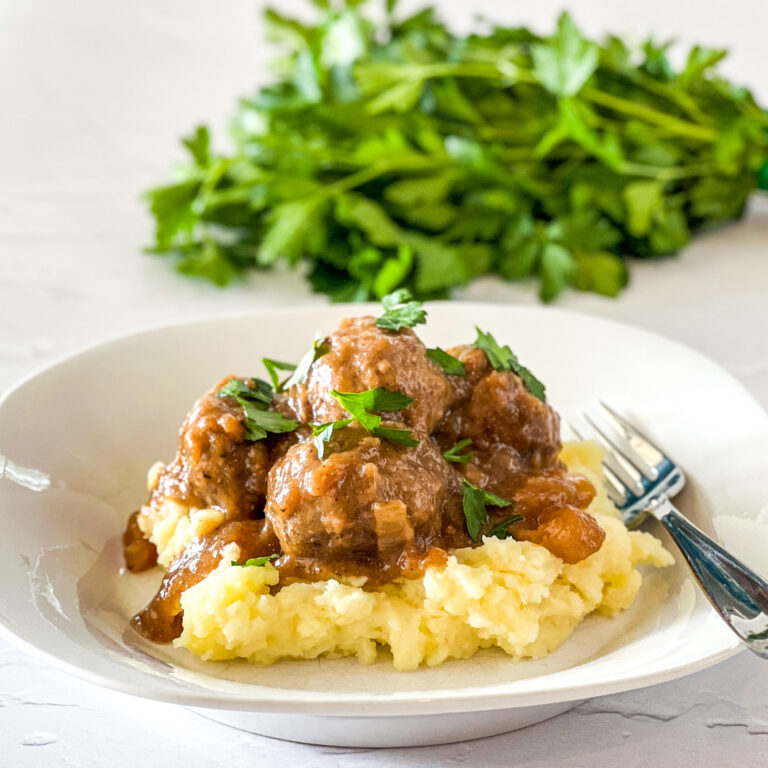 meatballs and gravy served over mashed potatoes