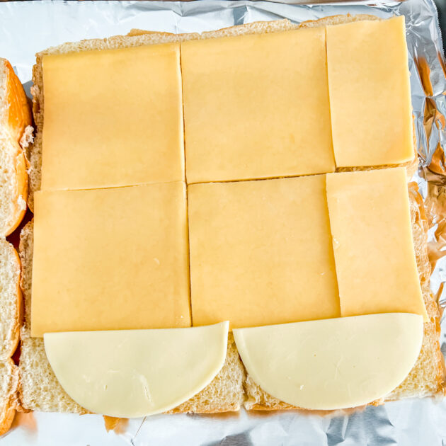 slices of cheese on Hawaiian rolls