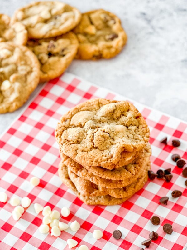 Stack of Mama Kelce's Chocolate Chip Cookies with pile of cookies in background