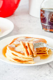 bite of stack of overnight buttermilk pancakes on fork