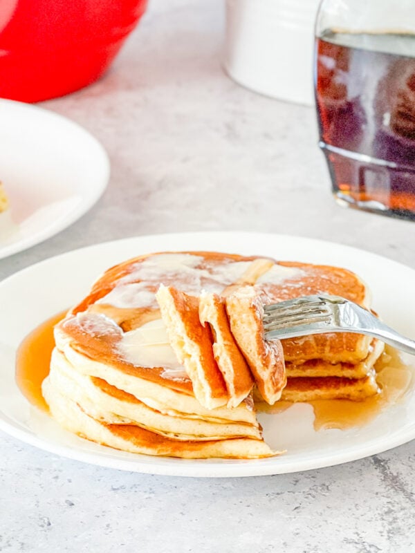 bite of stack of overnight buttermilk pancakes on fork