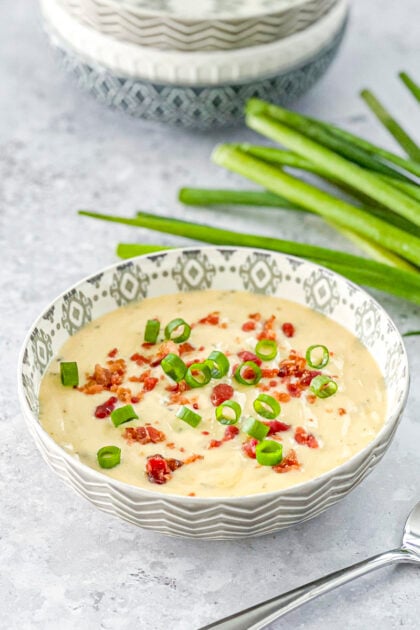 cheesy wild rice soup topped with crumbled bacon and green onions