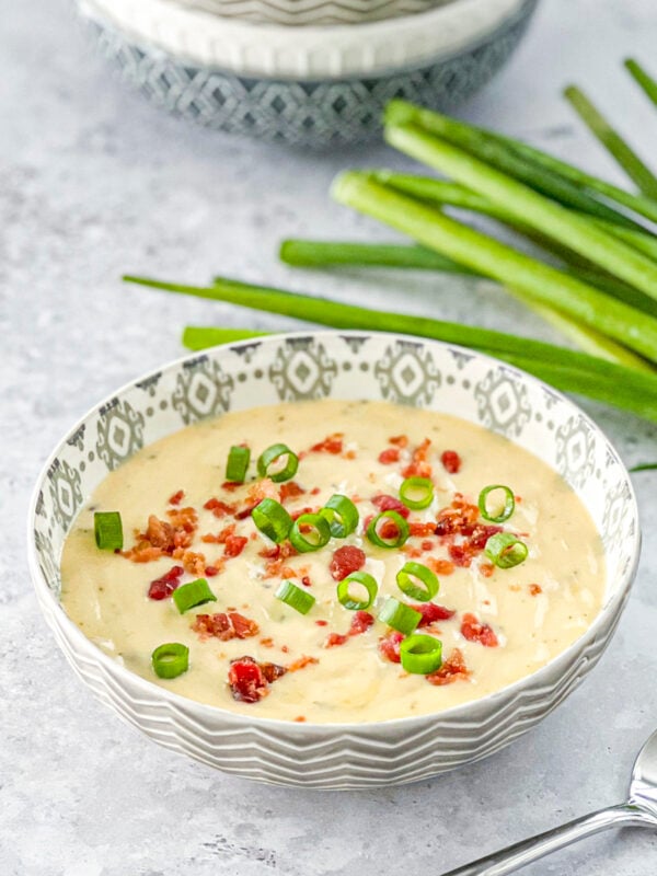 cheesy wild rice soup topped with crumbled bacon and green onions