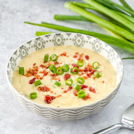 close up of cheesy wild rice soup in gray patterned bowl