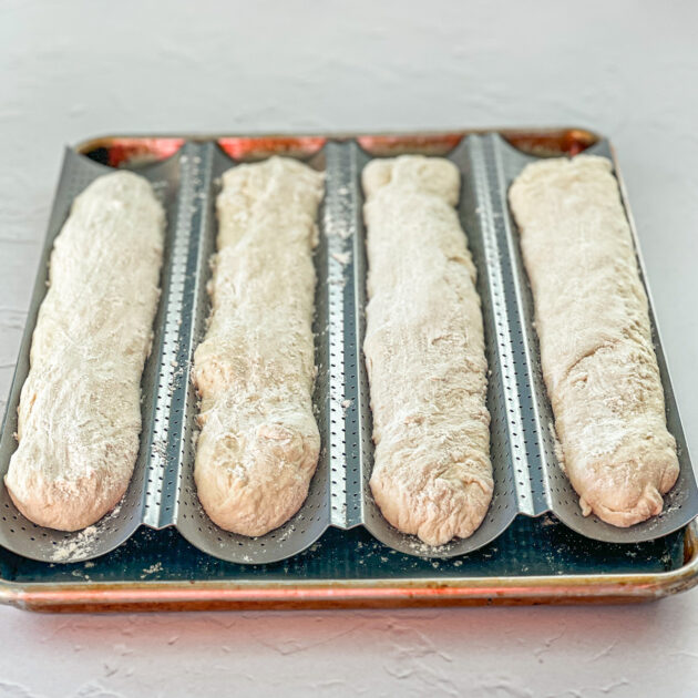 baguette loaves ready to rise in a baugette pan