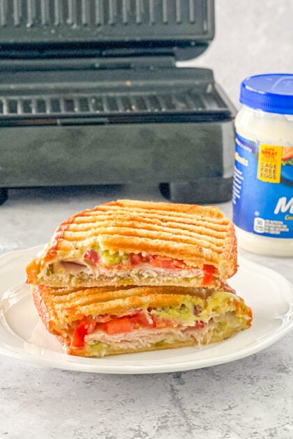 turkey bacon guacamole panini cut in half