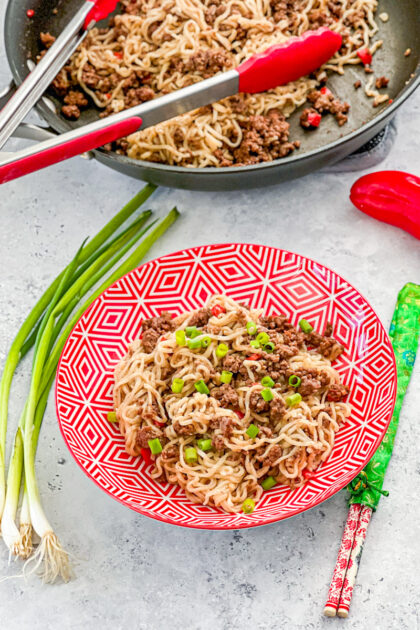 ground beef ramen noodles in skillet plus in red bowl