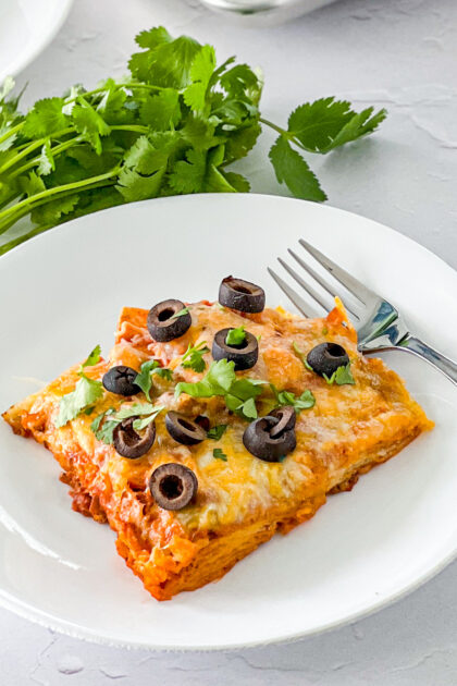 ground beef sheet pan enchilada served up with olives and cilantro