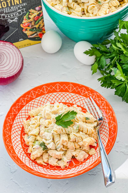 chicken pasta salad with bowl and ingredients in background