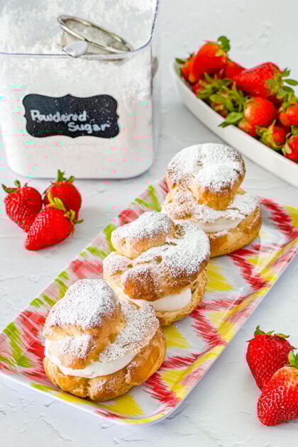 strawberry cheesecake cream puffs dusted with powdered sugar