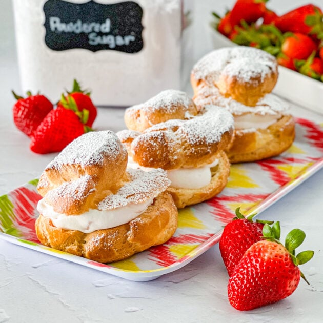 three strawberry cheesecake cream puffs