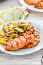 grilled garlic brown sugar chicken on a plate with a squash side