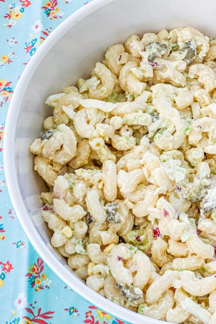 big bowl of creamy macaroni salad made with pickles, celery, and onion