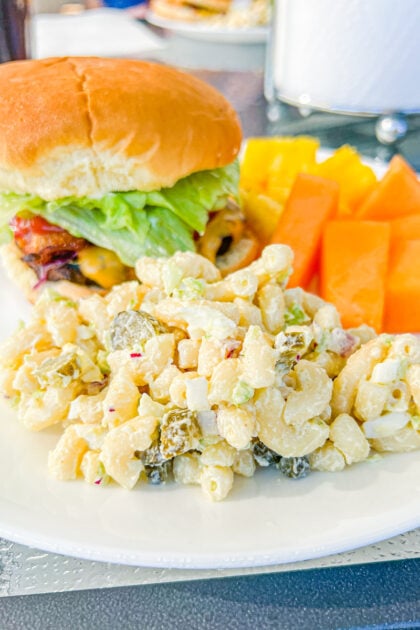 serving of pasta salad along with a hamburger and fresh fruit
