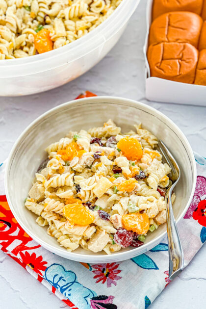 chicken pasta salad made with red grapes, mandarin oranges, pineapple, green onion, and celery