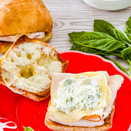 assembling turkey provolone sandwiches with basil mayo